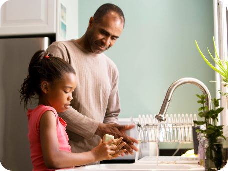 Father and her daughter preparing food together